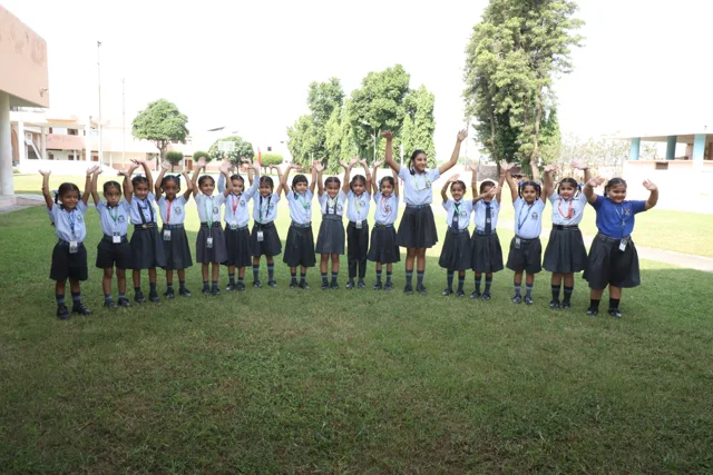 Kindergarten children stretching outdoors